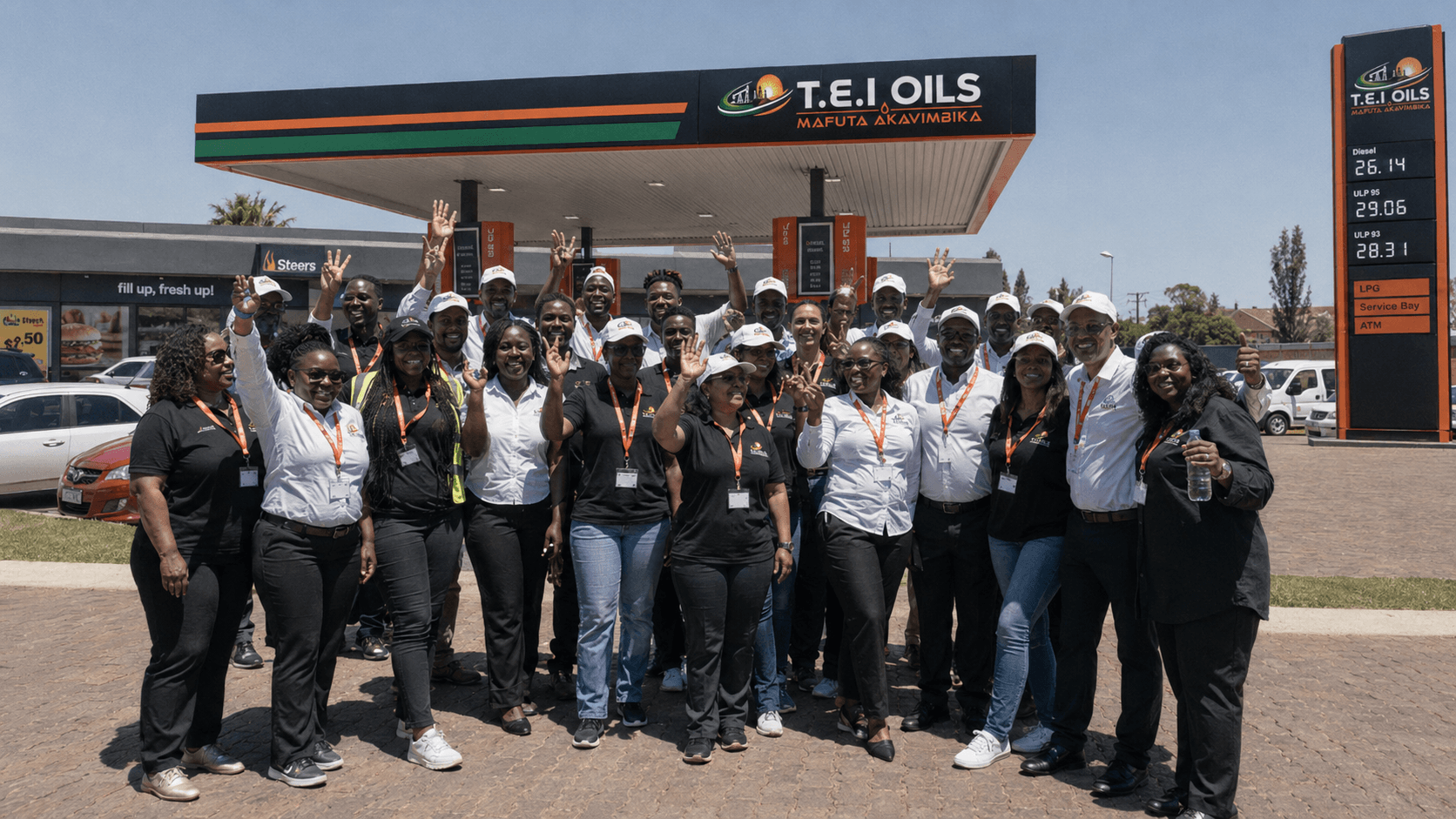 T.E.I Oils team celebrating at a fuel station